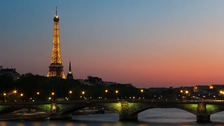 The Eiffel Tower and a Seine bridge at sunset