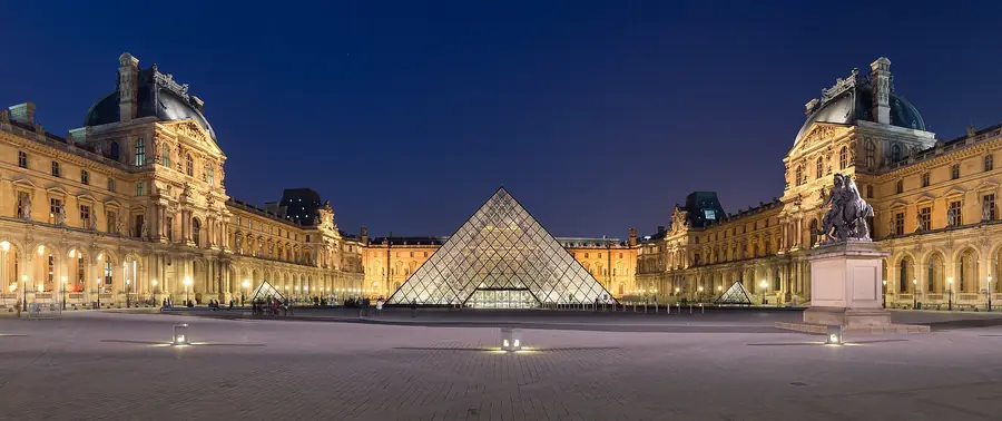 The glass pyramid of the Louvre lit at dusk