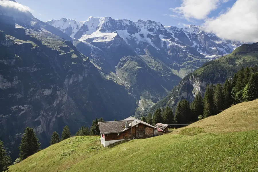 Chalet above the Lauterbrunnen valley with the snow-capped Bernese Alps behind